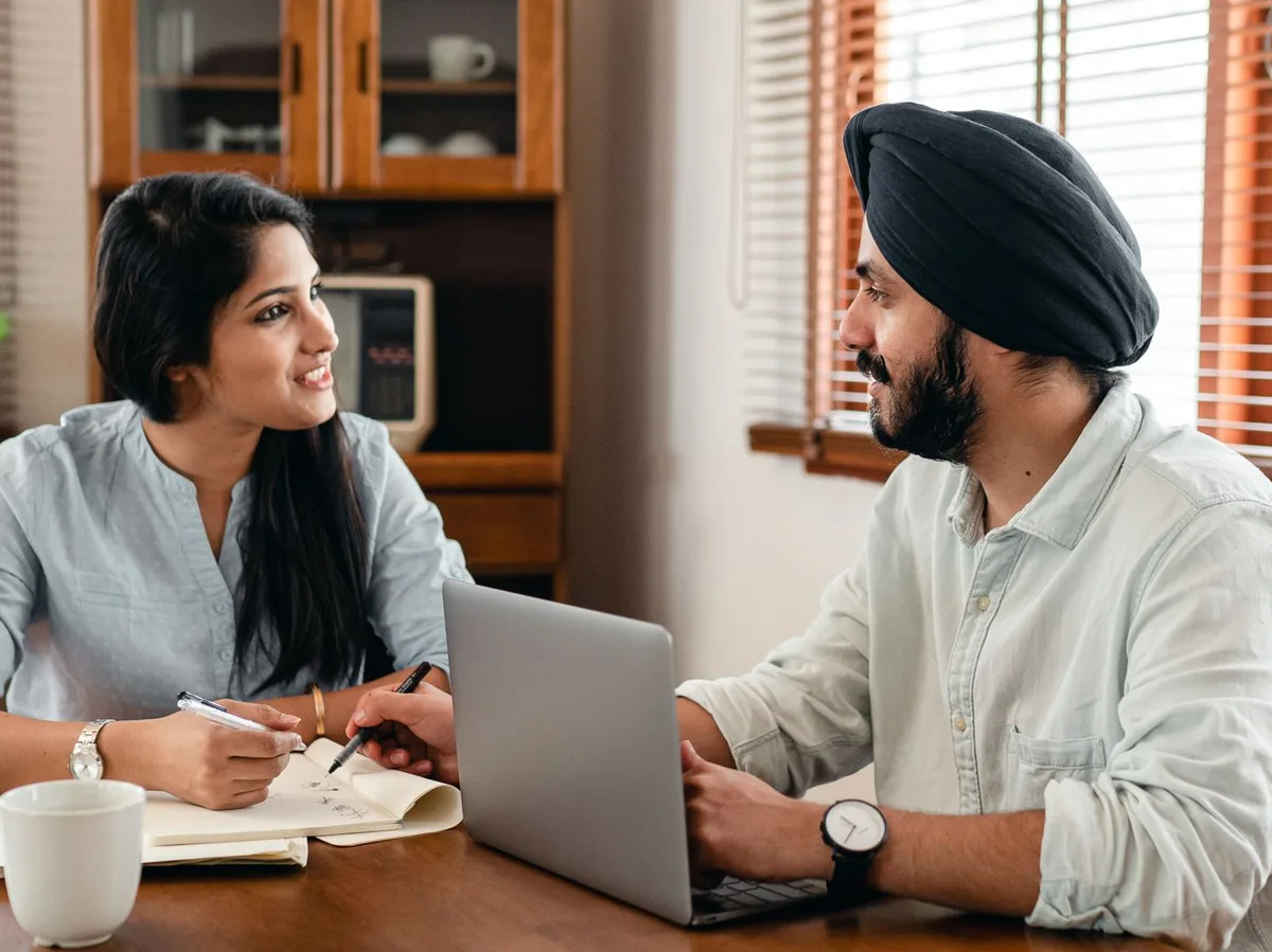Advisors discussing a client's business over a laptop